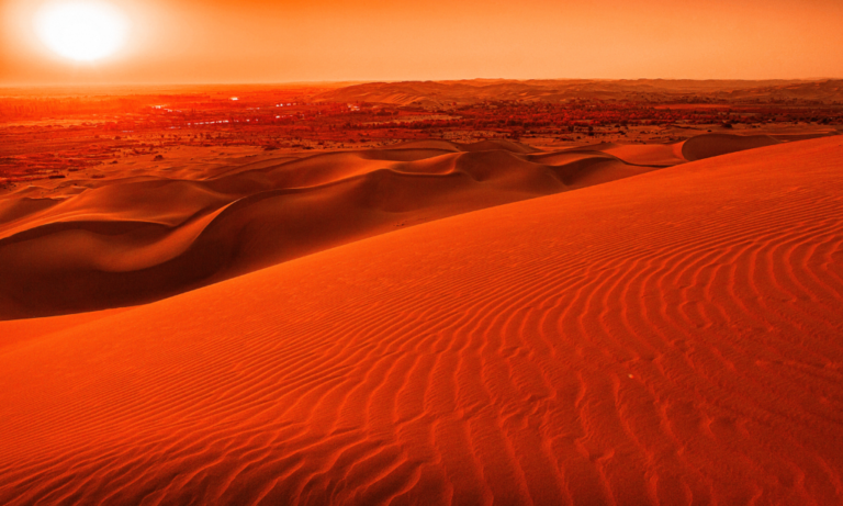orange-sunset-over-wavy-sand-dune-landscape
