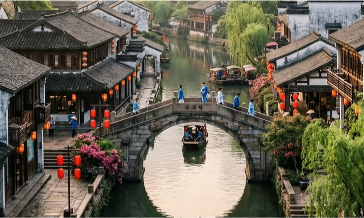 A traditional wooden tourist boat glides under the stone arch of Anlan Bridge, surrounded by historic riverside houses and red lanterns in Zhujiajiao Water Town during a luxury private tour with Lux Orient.