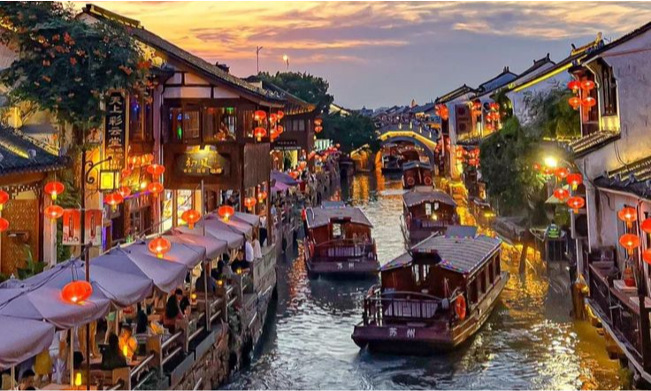 A view from a private balcony of a traditional, lantern-lit canal in the historic Shantang Street district, showcasing exclusive chartered water-taxis and riverside luxury dining during a bespoke cultural immersion tour with Lux Orient.