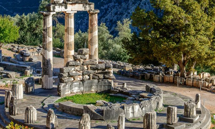 The circular stone foundations and remaining fluted Doric columns of an ancient Greek sanctuary during a luxury bespoke heritage tour departing from Athens with Lux Orient.