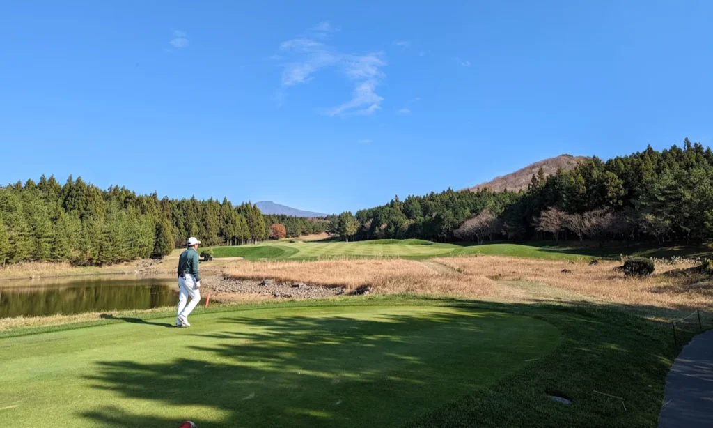 A sweeping view of the pristine, manicured green fairways, sand traps, and scenic water hazards at the exclusive Club at Nine Bridges on Jeju Island, South Korea, during a luxury private golf holiday with Lux Orient.
