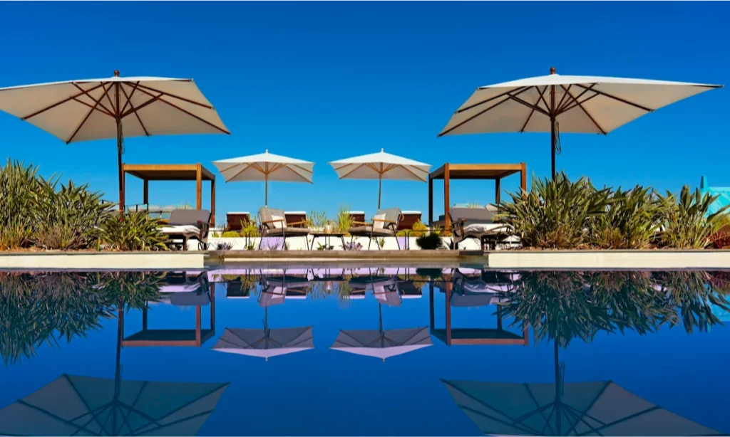 The elegant colonial architecture and sparkling private swimming pool overlooking the blue Indian Ocean at the luxury Blue Margouillat Seaview Hotel – Relais & Châteaux in Saint-Leu, La Réunion, during an exclusive vacation with Lux Orient.
