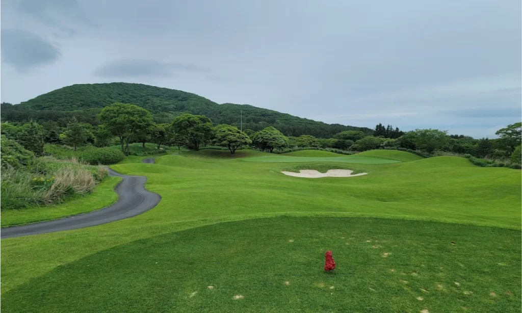 The meticulously manicured fairways, elegant water features, and scenic mountain backdrops of the exclusive Elysian Jeju Country Club in Jeju Island, South Korea, during a premium private luxury sports tour with Lux Orient.