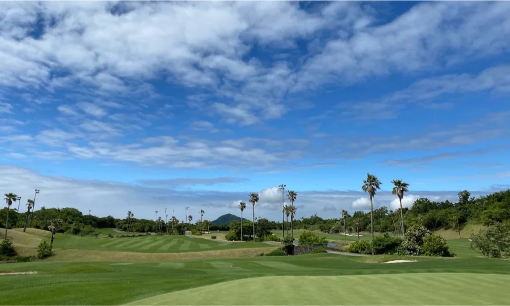 The pristine green fairways, lush tropical landscaping, and scenic volcanic mountain backdrop of the exclusive Teddy Valley Golf & Resort on Jeju Island, South Korea, during a luxury private golf tour with Lux Orient
