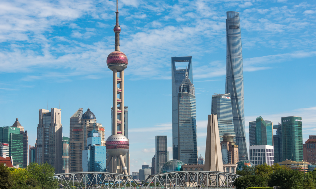 The soaring glass skyscrapers and neon-lit architectural towers of the Lujiazui Financial Zone skyline at dusk in Pudong, Shanghai, during an exclusive private luxury tour with Lux Orient.