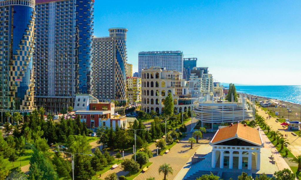 The striking modern skyline of Batumi featuring unique architectural skyscrapers and luxury hotels lit up along the Black Sea coastline in Georgia during an exclusive private VIP tour with Lux Orient.