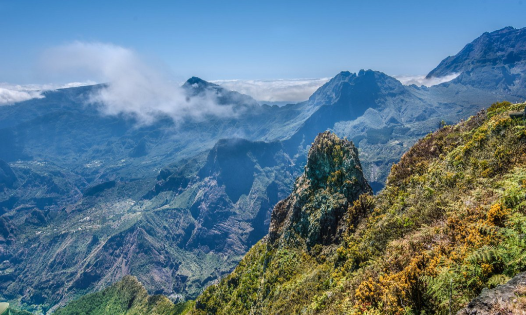 The dramatic rocky cliffs of the Maïdo Viewpoint overlooking the deep volcanic valleys and isolated mountain villages of the Mafate Cirque in La Réunion, during an elite private luxury tour with Lux Orient.