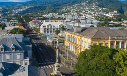The historic colonial mansions and lush tropical gardens lining the scenic Rue de Paris in Saint-Denis, La Réunion, during an exclusive private city tour with Lux Orient.
