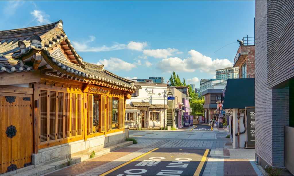The elegant blend of traditional Korean wooden hanok architecture and modern cafe storefronts along the scenic, winding streets of Samcheong-dong, Seoul, South Korea during a luxury private cultural tour with Lux Orient.