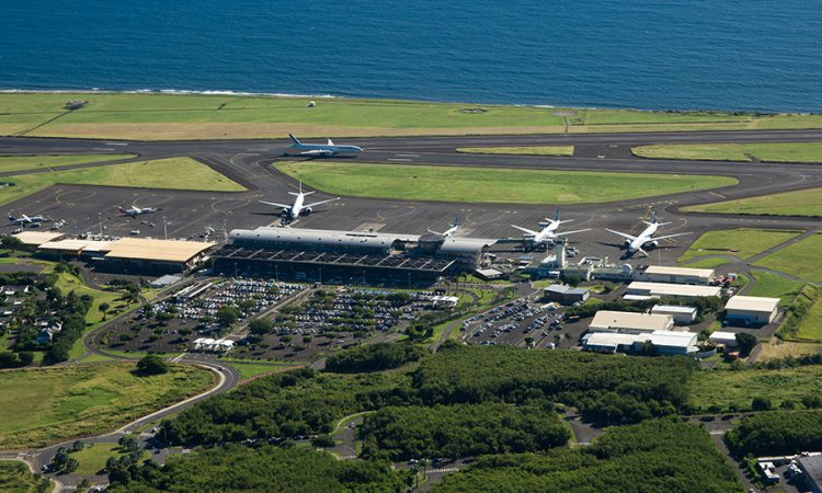 The modern, sweeping architectural exterior and departure terminal gates of the Roland Garros Airport in Sainte-Marie, La Réunion, during an exclusive private VIP travel transfer with Lux Orient.