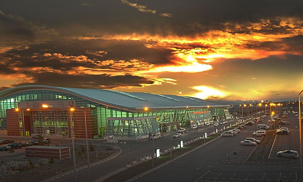 The modern architectural interior and premium passenger check-in area of Tbilisi International Airport in Georgia during an exclusive private airport concierge departure service with Lux Orient.