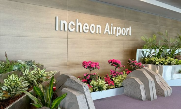 The ultra-modern architectural ceiling, sleek terminal interior, and pristine check-in desks of Incheon International Airport in South Korea during a luxury private concierge transfer with Lux Orient.
